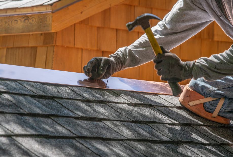 A roofer works on a roof after the CAM who hired him became better at managing maintenance costs