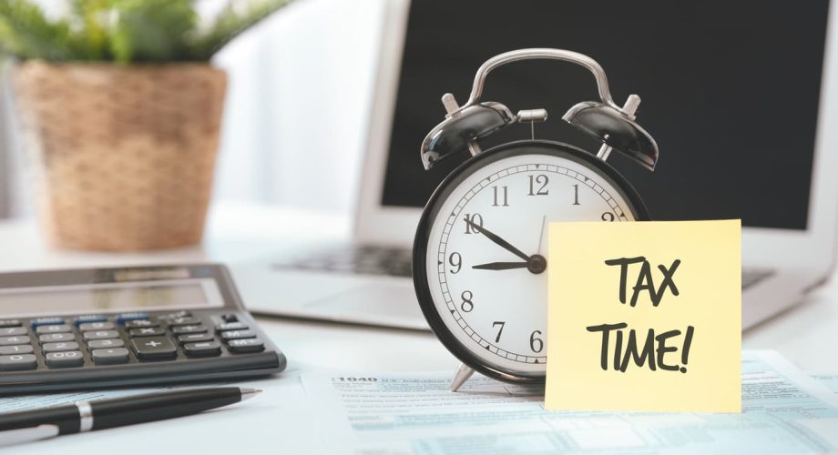 A small business owner’s desk with a reminder about tax time and tax tips