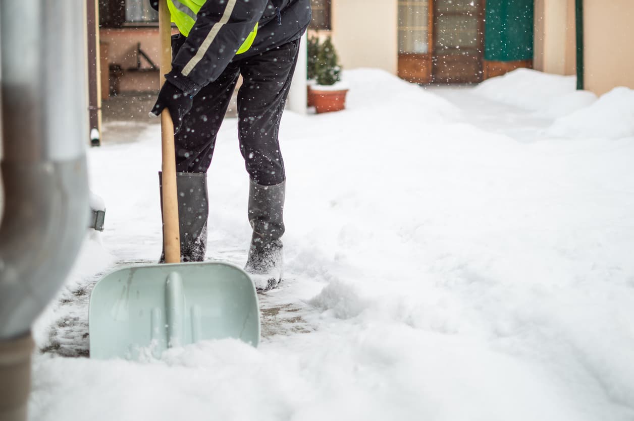 A vendor employing ice removal tips to remove ice and snow on a driveway