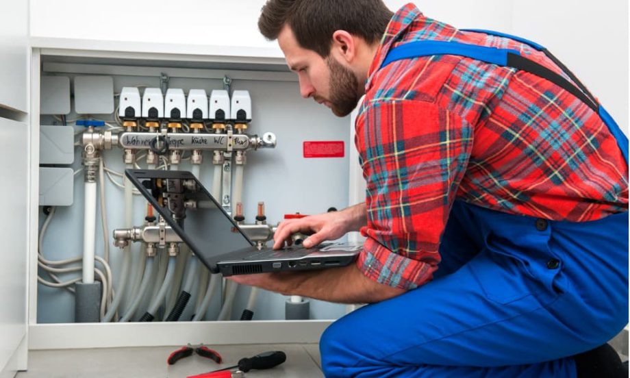 A picture of a tech-savvy vendor working on a building’s pipes