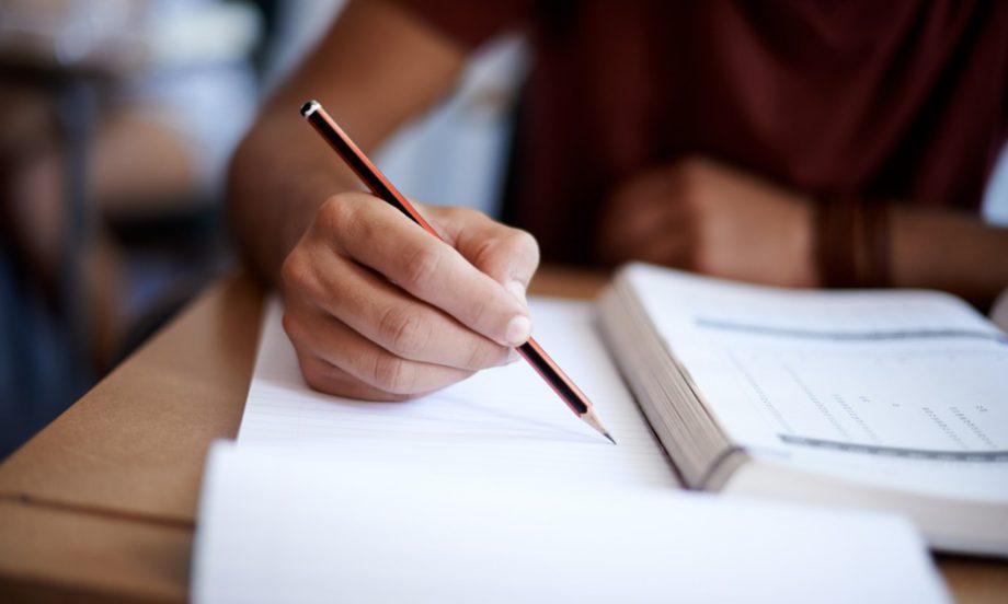 A student earning a community association license by taking an exam