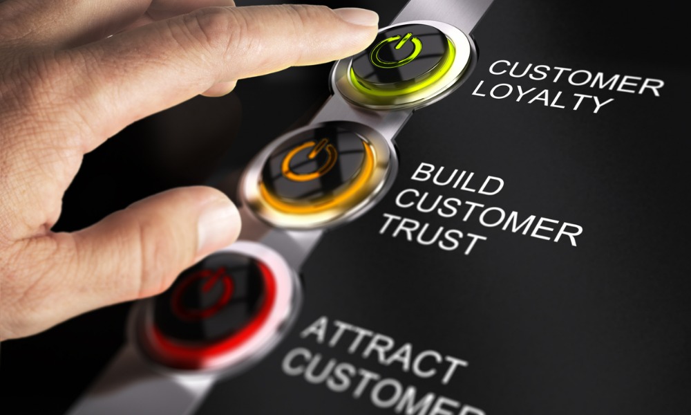 A finger pressing a button labeled “customer loyalty”