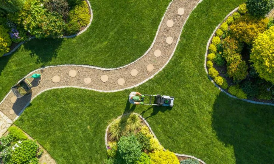 An overhead shot of a landscaping professional fixing a community walkway.