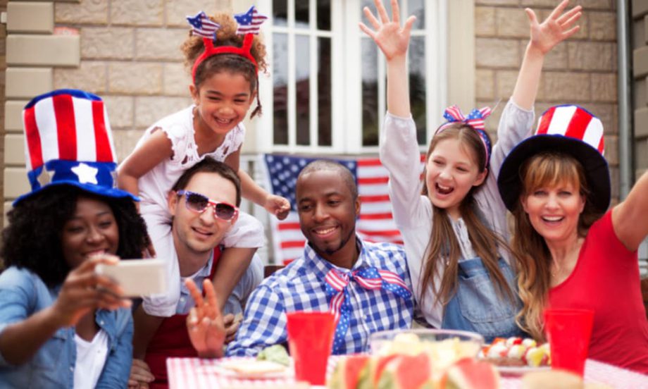 Two families celebrating the 4th of July around a picnic table.